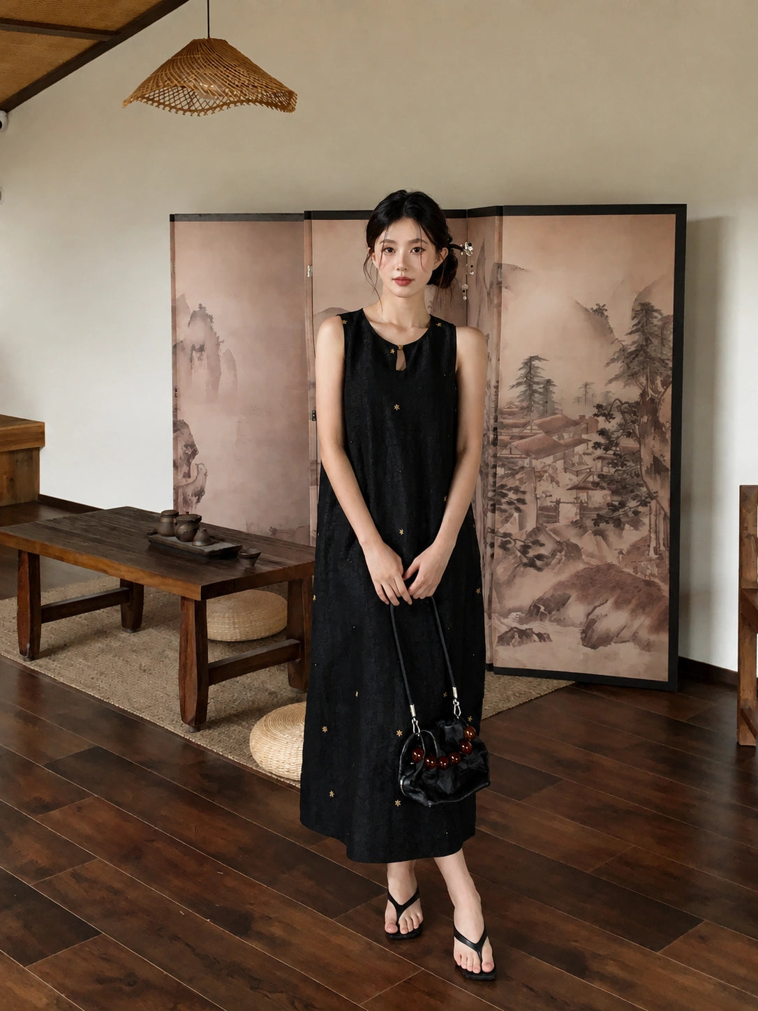 Full body view of elegant black silk maxi dress with embroidered stars and minimalist Chinese-inspired style