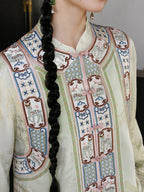 Close-up of the vest’s embroidered floral panels, decorative buttons, and colorful traditional-inspired motifs.