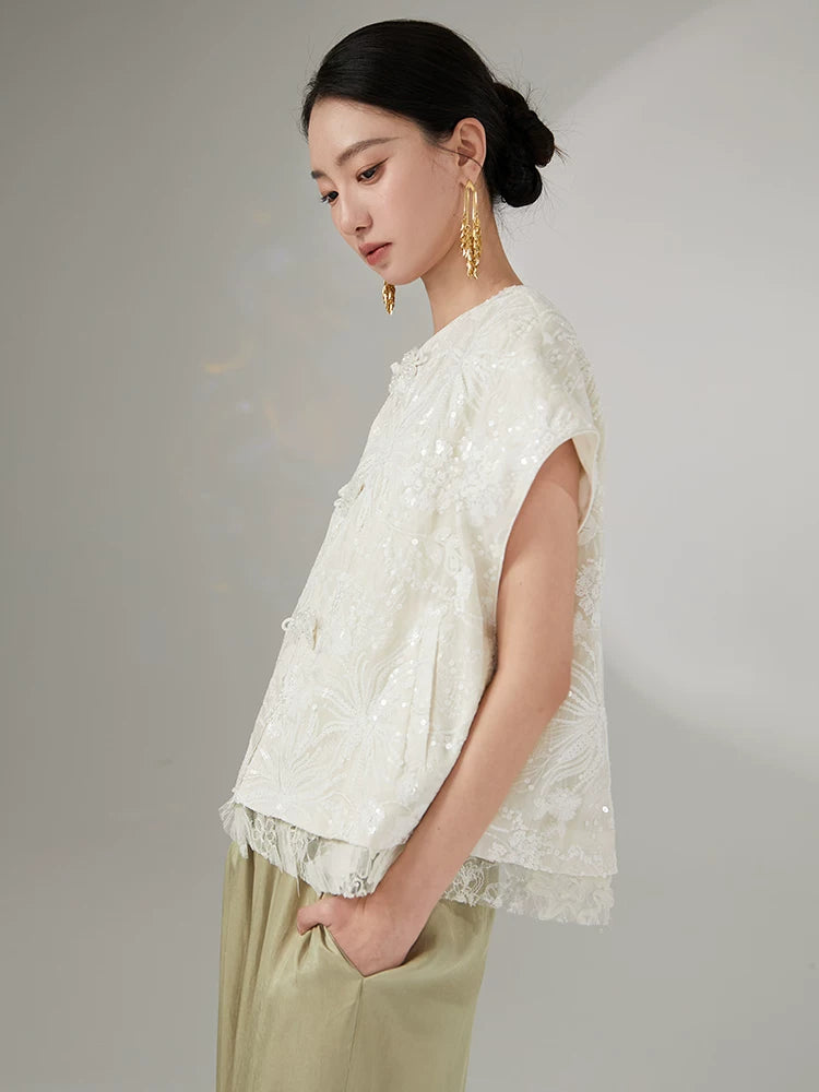 Side profile of an embroidered Chinese-style short sleeve jacket.