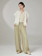 Women's embroidered jacket styled with light wide-leg trousers.