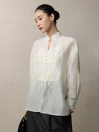 Side view of a lightweight embroidered lyocell linen blend blouse with a relaxed silhouette.