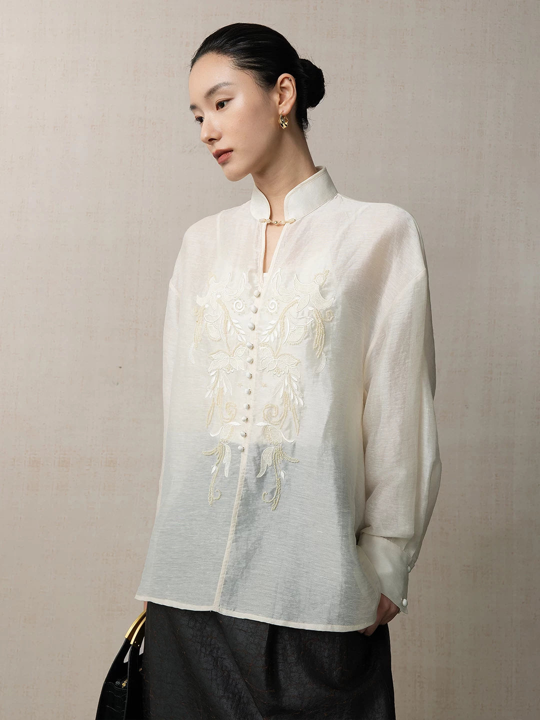 Side view of a lightweight embroidered lyocell linen blend blouse with a relaxed silhouette.