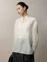 Side view of a lightweight embroidered lyocell linen blend blouse with a relaxed silhouette.