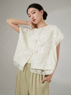 Women's embroidered short sleeve jacket with floral embroidery and lace trim.