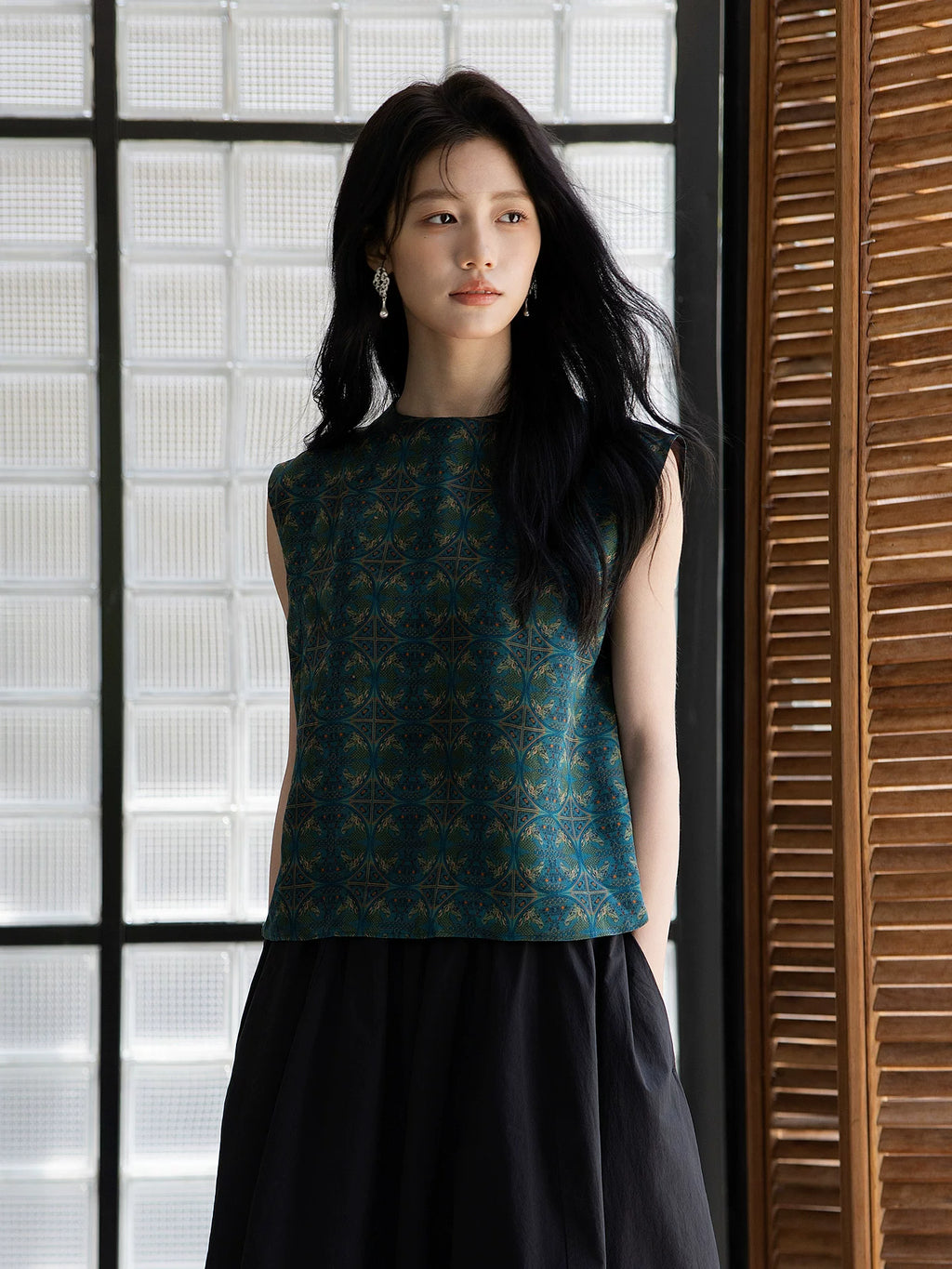 Elegant emerald silk sleeveless top featuring a refined geometric pattern.