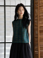 Elegant emerald silk sleeveless top featuring a refined geometric pattern.