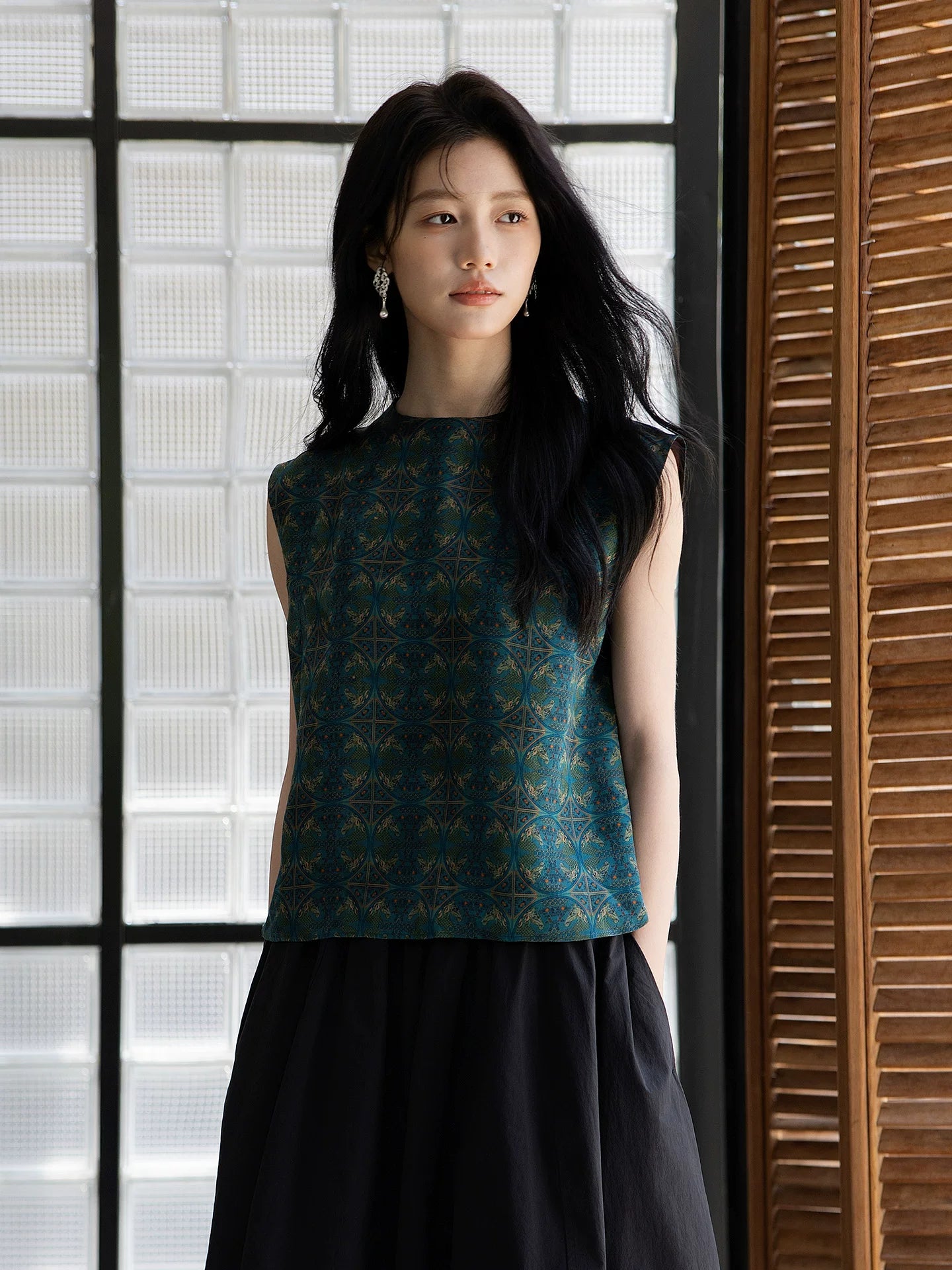 Elegant emerald silk sleeveless top featuring a refined geometric pattern.