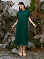 Emerald green viscose midi dress with relaxed silhouette and front slit.
