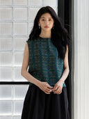 Front view of an emerald green sleeveless mulberry silk blouse with geometric print.