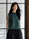 Relaxed fit emerald silk blouse styled with a minimalist black skirt.