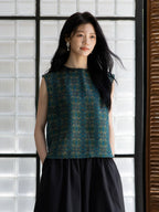 Relaxed fit emerald silk blouse styled with a minimalist black skirt.