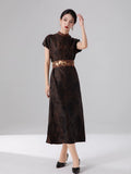 Woman wearing an espresso brown 100% mulberry silk jacquard maxi dress with a relaxed Oriental-inspired silhouette.