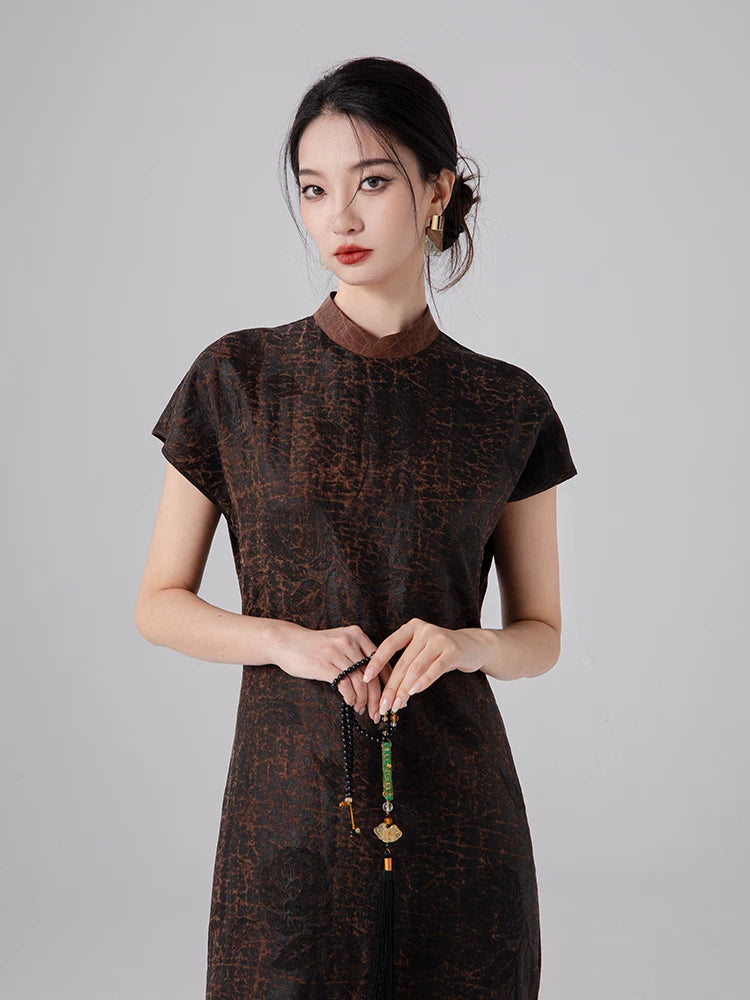 Close-up of the jacquard silk texture and stand collar on an espresso brown mulberry silk dress.