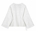 Back view of the white blouse with tone-on-tone floral jacquard and wide sleeves