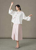Full-length view of the model wearing the blouse with a pale pink skirt