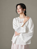 Close view of the model wearing the blouse, showing its wide sleeves and embroidered front