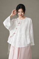 Front view of the model wearing the white embroidered blouse and pink skirt