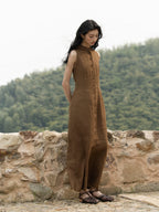 Woman wearing a sleeveless linen mandarin collar maxi dress outdoors