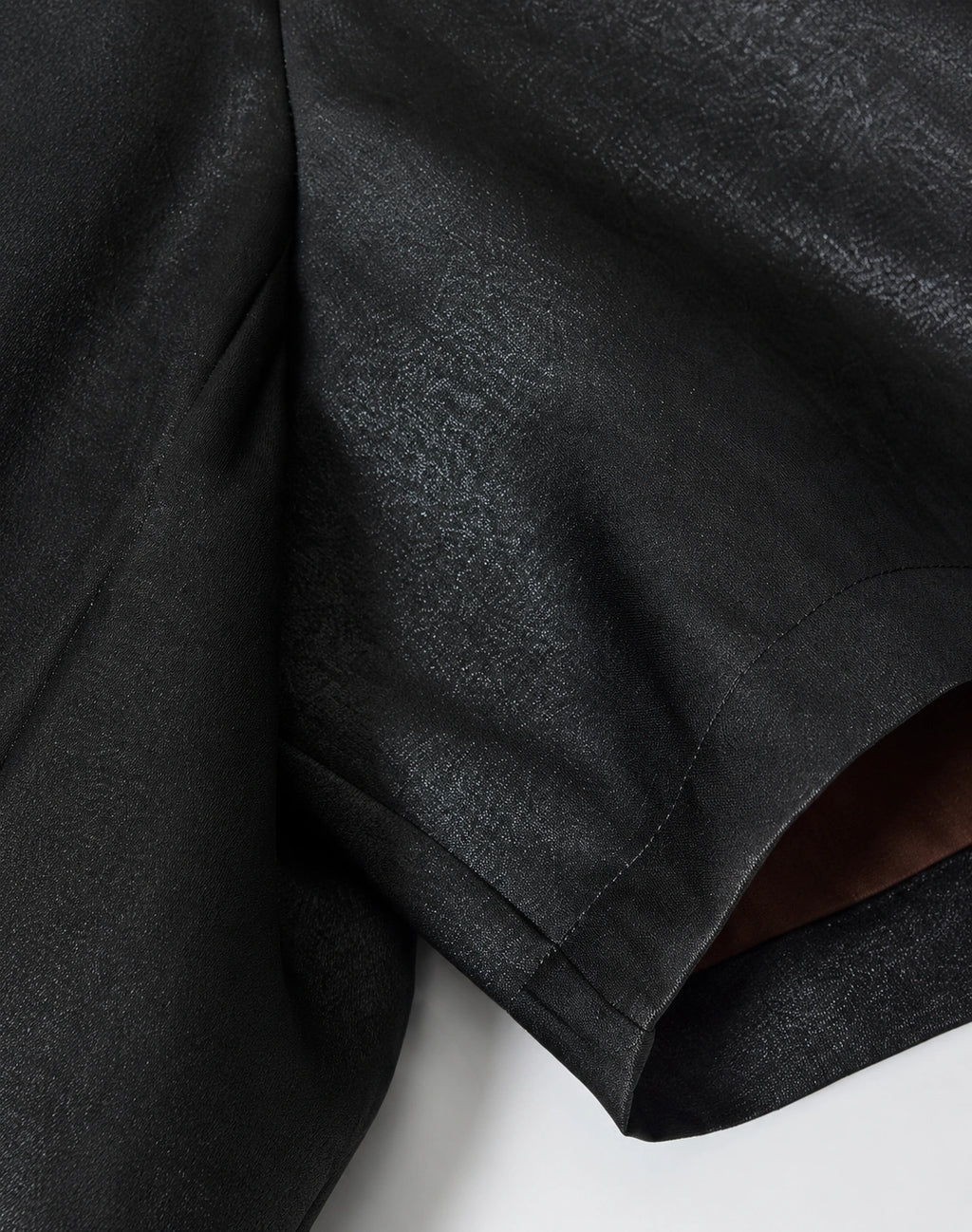Close-up of the smooth black 40-momme mulberry silk satin fabric and short-sleeve construction
