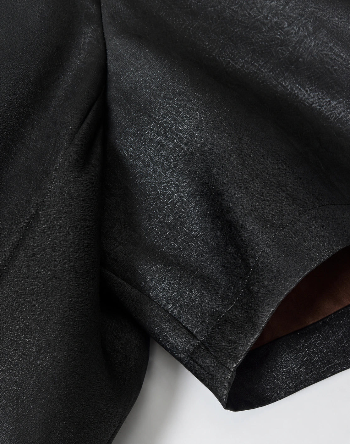 Close-up of the smooth black 40-momme mulberry silk satin fabric and short-sleeve construction