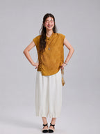 Model wearing an antique-gold Gambiered Silk jacquard top with ivory wide-leg trousers.