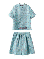 Gambiered Silk aqua mulberry silk set with a butterfly-patterned shirt and matching wide-leg shorts.