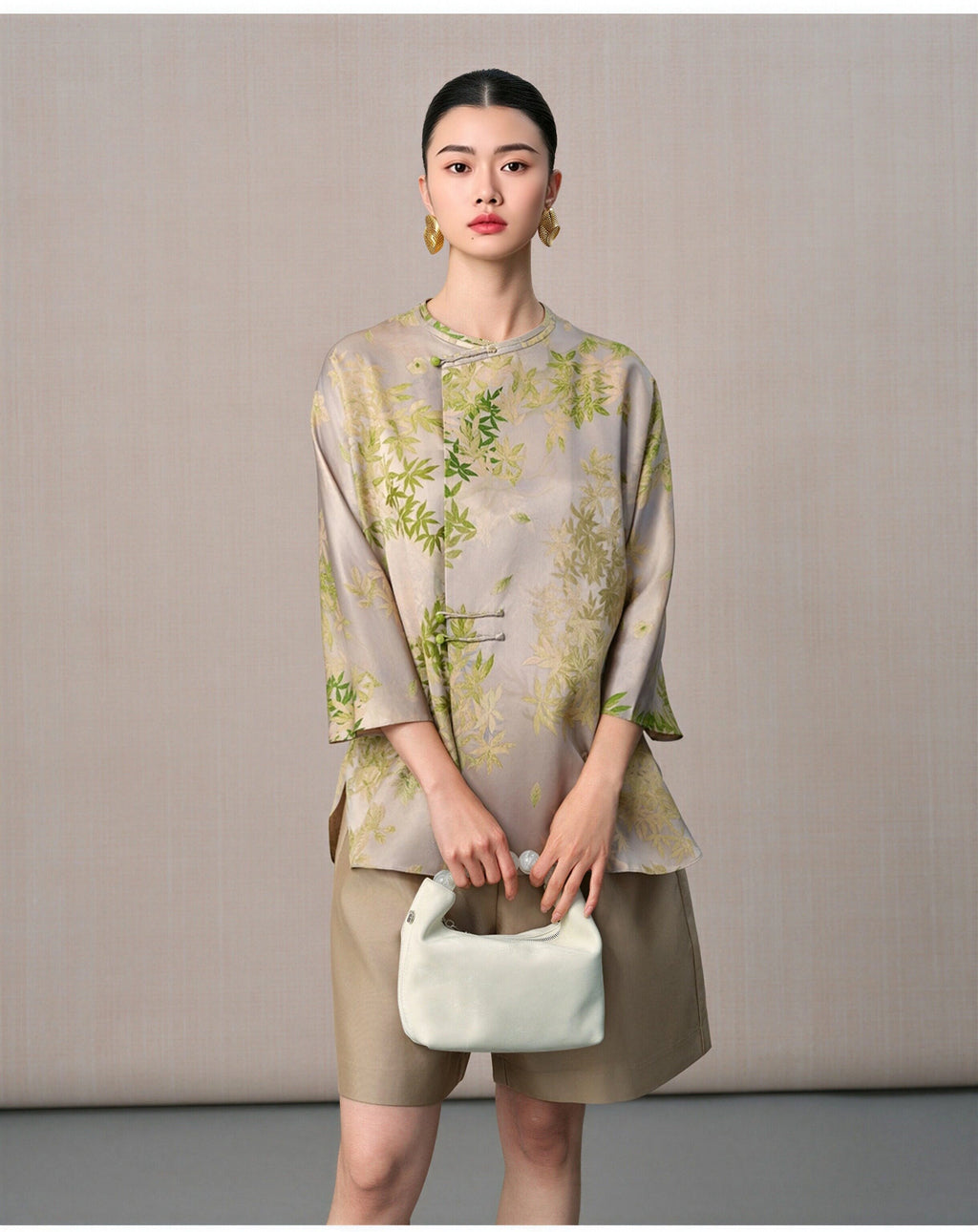 Front portrait of a model wearing the New Chinese mulberry silk blouse with botanical leaf print