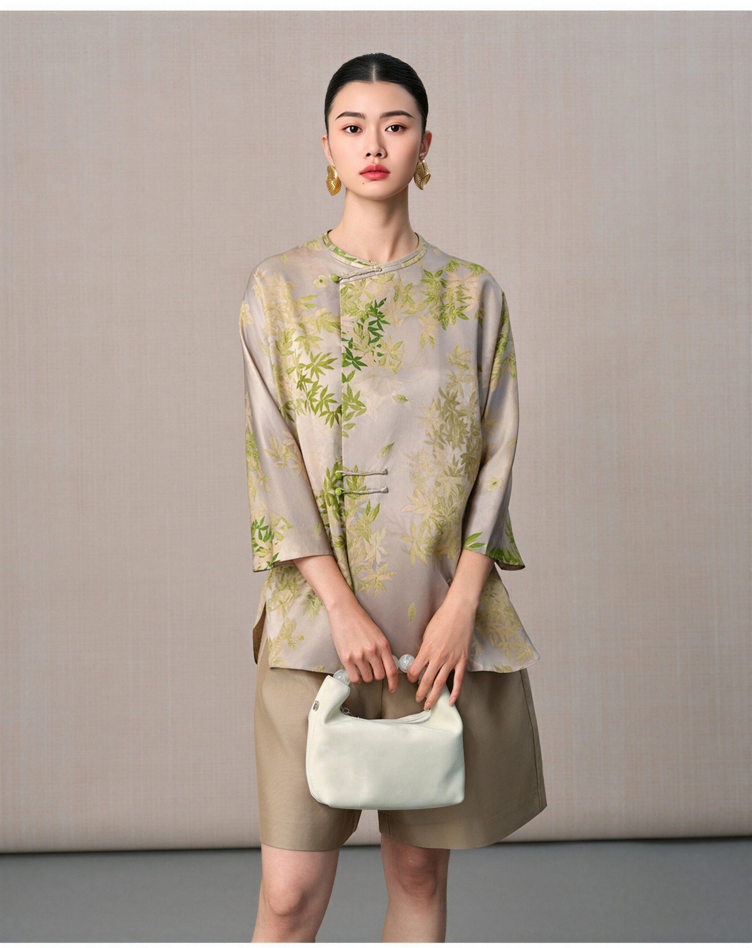 Front portrait of a model wearing the New Chinese mulberry silk blouse with botanical leaf print