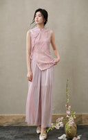 Front view of a fitted blush-pink cut-velvet vest with asymmetric frog buttons and side ties