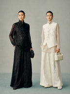 Black and ivory versions of the New Chinese asymmetric vest styled over coordinated wide-leg outfits