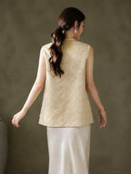 Back view of the relaxed sleeveless vest with an all-over gold Baoxiang floral pattern