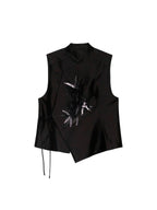 Black asymmetric wool and mulberry silk vest with a stand collar, concealed closure and beaded bamboo motif