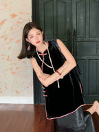 Model wearing a black sleeveless top with a diagonal Chinese-style closure
