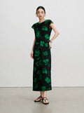 Side view of a slim-fitting black silk maxi dress with green floral print and cap sleeves.