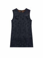Flat lay of a black sleeveless 100% mulberry silk H-line dress with a round neckline and subtle floral jacquard pattern.