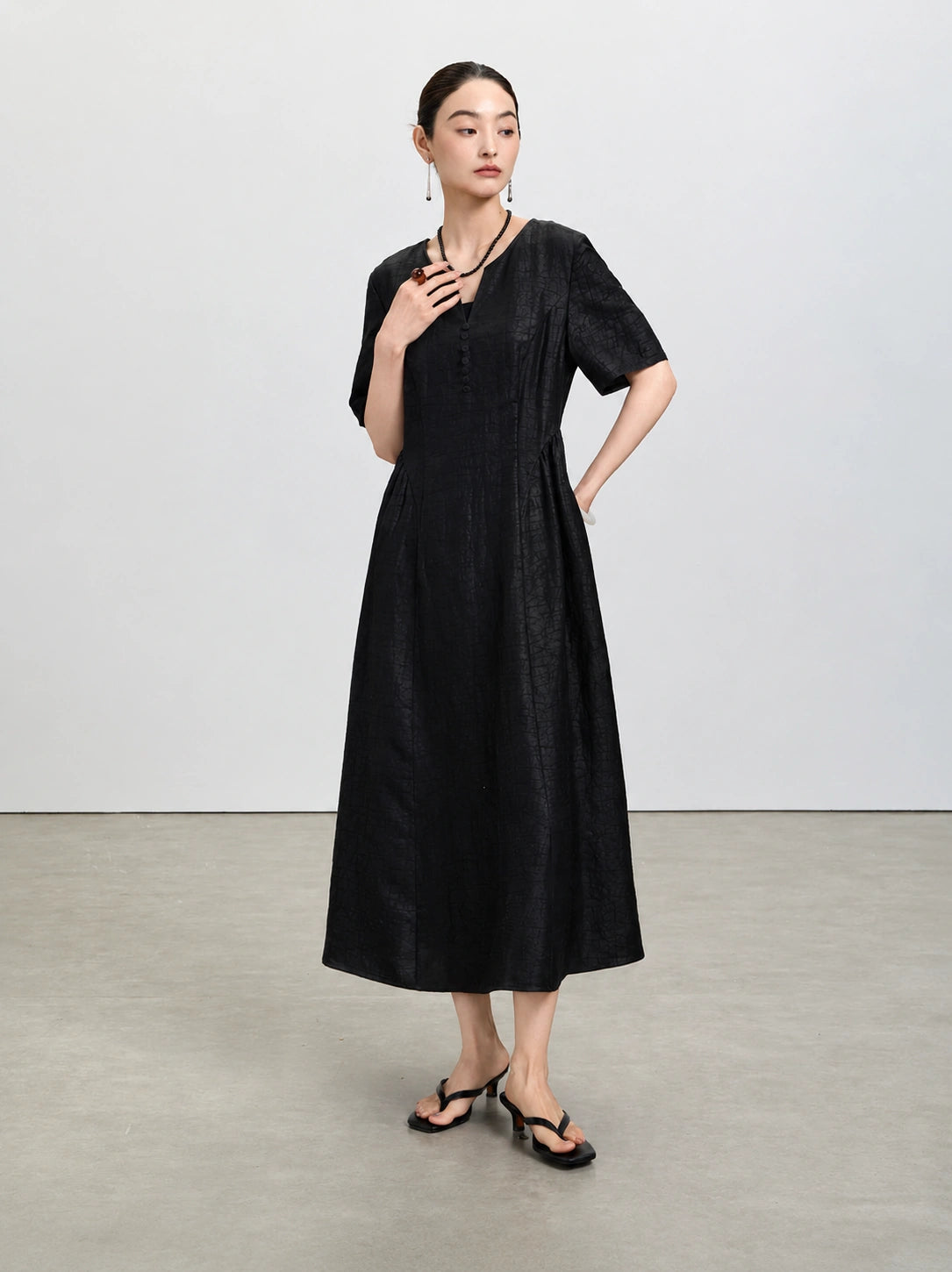 Full-length view of the black Xiangyunsha dress with elbow-length sleeves and a defined waist