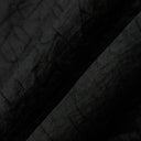 Macro view of the lightweight black Gambiered Silk fabric with a subtle tortoiseshell-inspired texture.