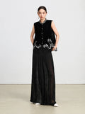 Full-length styling of a black mulberry silk velvet vest with tonal wide-leg trousers.