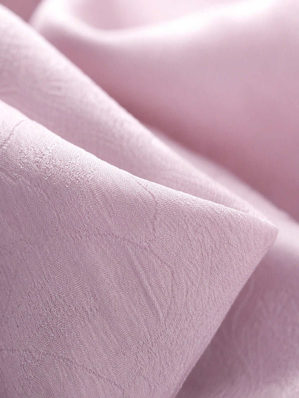 Close-up of blush-lilac textured rayon jacquard with subtle tonal floral motifs.
