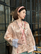Model wearing a relaxed blush pink Chinese-inspired silk-blend jacket