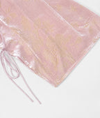 Close-up of blush-pink silk-blend cut-velvet fabric with champagne floral motifs and adjustable side ties