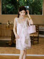Model wearing a blush pink floral silk-blend sleeveless dress with a relaxed H-line silhouette
