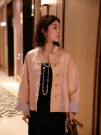 Model wearing a blush pink silk-blend jacquard jacket with a mandarin collar