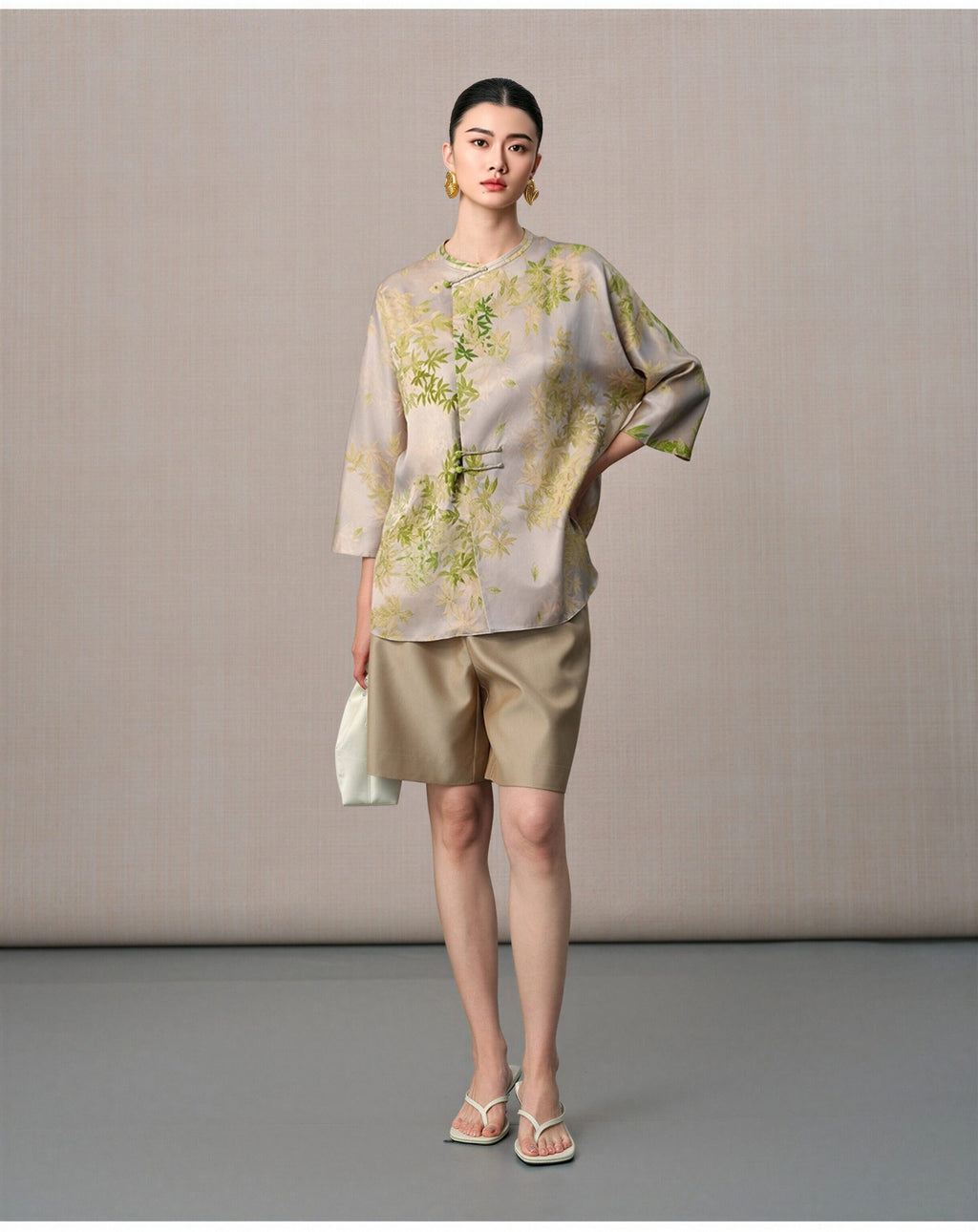 Model styling the botanical mulberry silk blouse with three-quarter sleeves and an asymmetric front