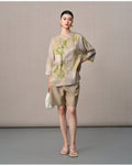 Model styling the botanical mulberry silk blouse with three-quarter sleeves and an asymmetric front