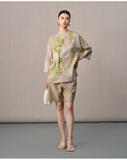 Model styling the botanical mulberry silk blouse with three-quarter sleeves and an asymmetric front