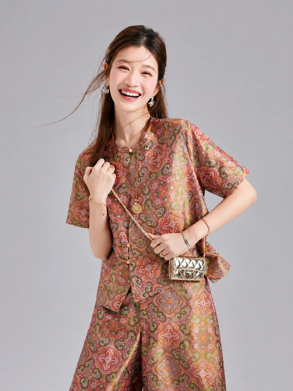 Close view of a relaxed Shu brocade silk jacket with short sleeves and decorative knotted closures.