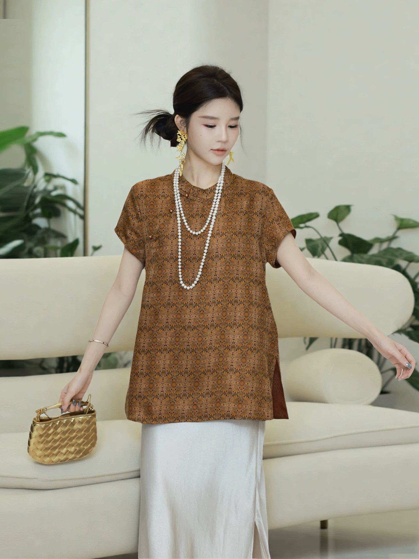 Model wearing a relaxed brown patterned mulberry silk pullover top with short straight sleeves