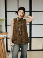 Model wearing a brown abstract-patterned silk top with casual denim trousers