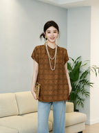 Model styling a relaxed brown mulberry silk top with light blue jeans